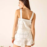 Woman wearing a white dress with floral arrangements in the foreground