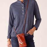 MERSEA ladies' travel-ready muted blue long-sleeve ruffled henley top.