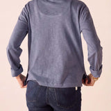 Back view of the blue long sleeve ruffled henley top.