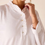 White long-sleeve ruffle Henley top with button front and gathered neck detail.