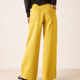 Mustard yellow wide-leg 5-pocket jeans in a soft, woven fabric with prominent pocket detailing.
