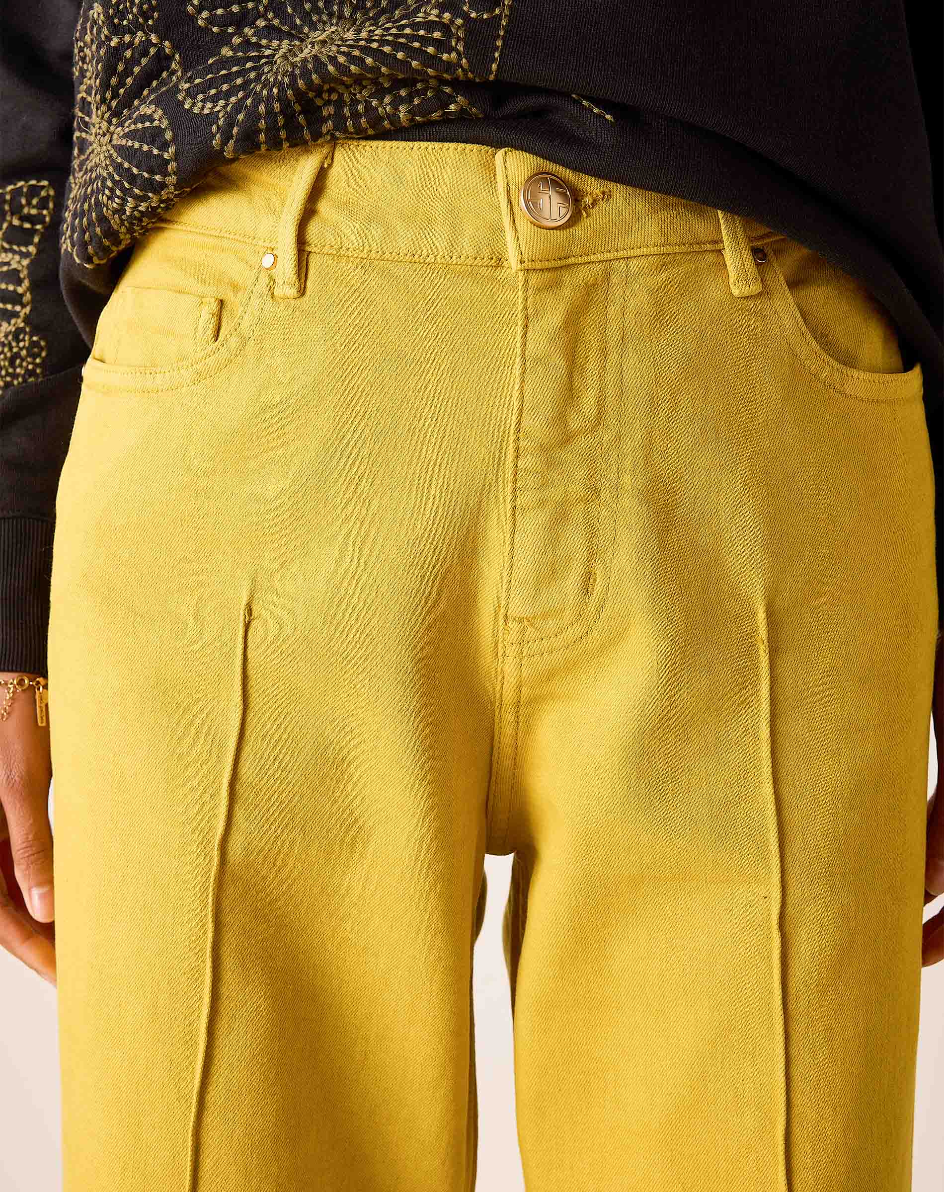 Mustard yellow 5-pocket relaxed-fit denim jeans with front and back pockets.
