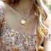woman wearing mersea colab scorpio zodiac pendants with chain