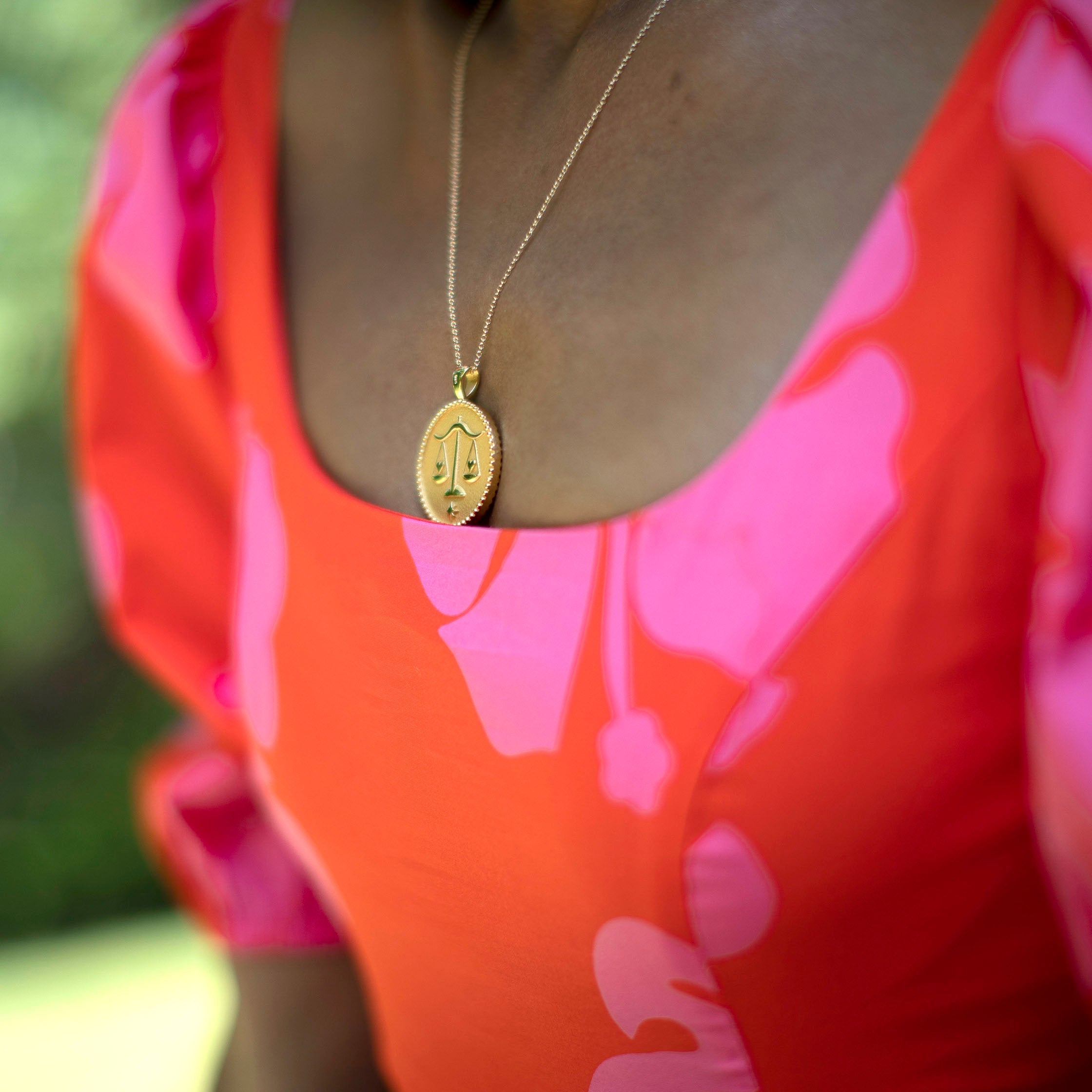 woman wearing mersea colab Libra zodiac pendant with chain