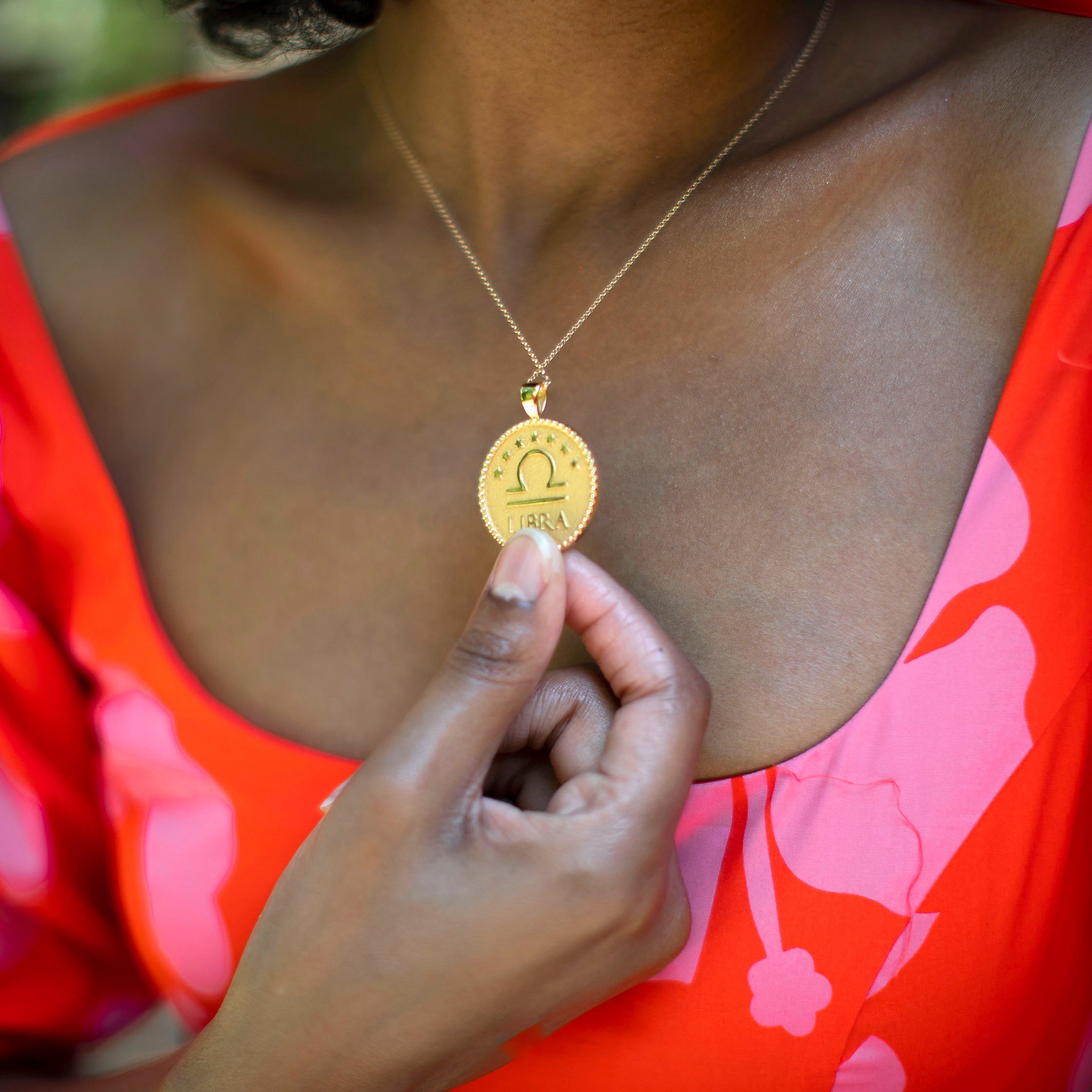 woman wearing mersea colab Libra zodiac pendant with chain