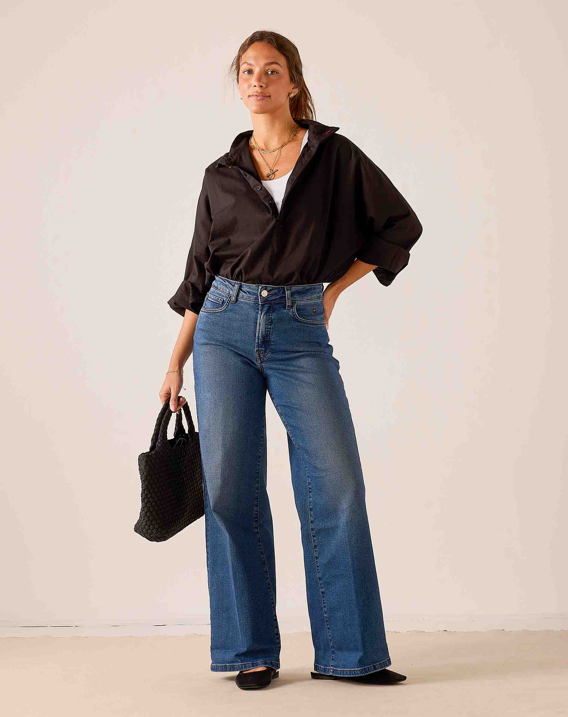Women's travel-friendly indigo blue wide-leg denim jeans with a relaxed fit.