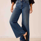 Medium blue wide-leg denim pants with a relaxed fit and flat front construction.