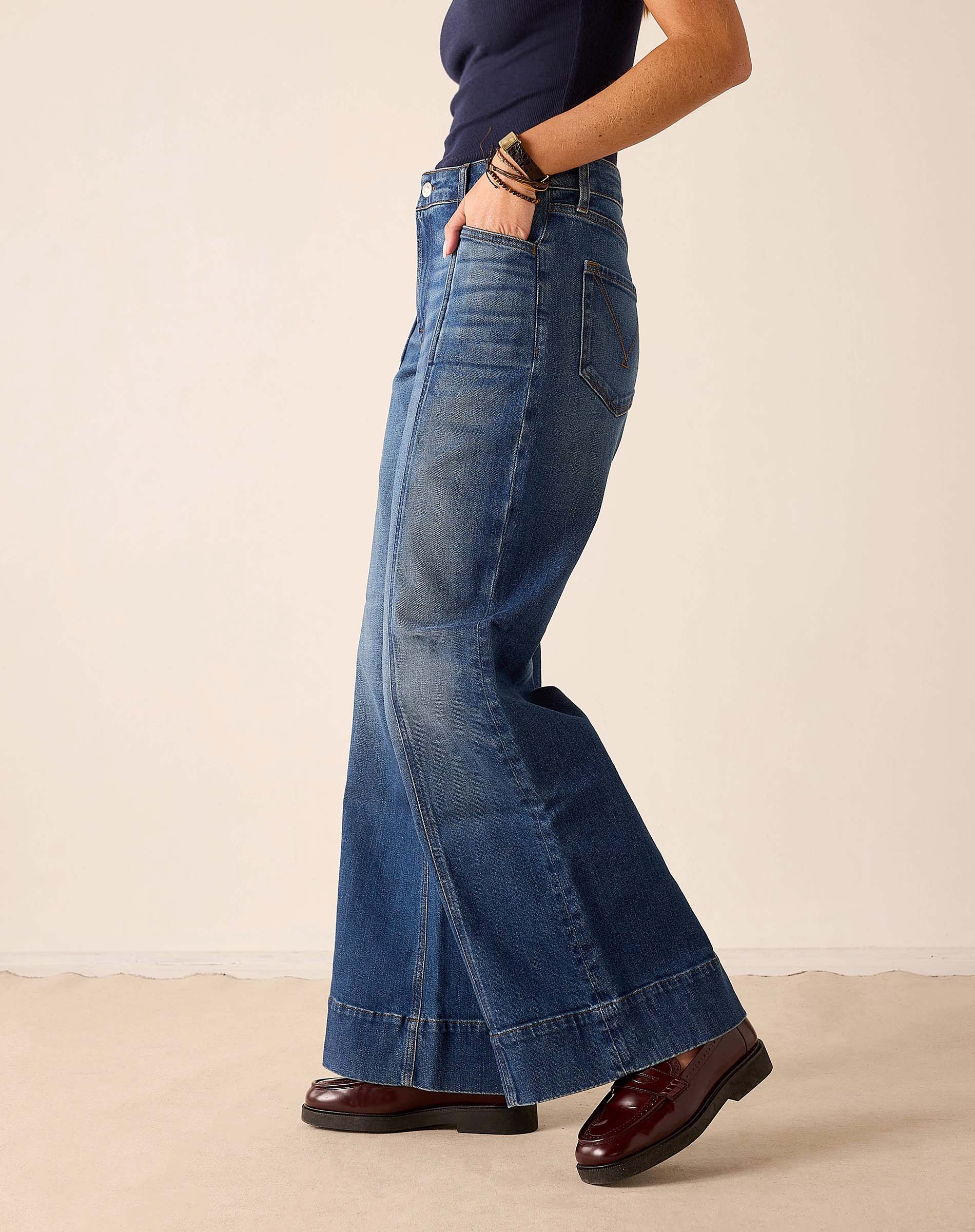 Deep pacific blue wide-leg jeans with stitched hem detail.