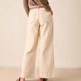 Oat-colored wide-leg pants featuring back pocket details and a clean, relaxed silhouette.