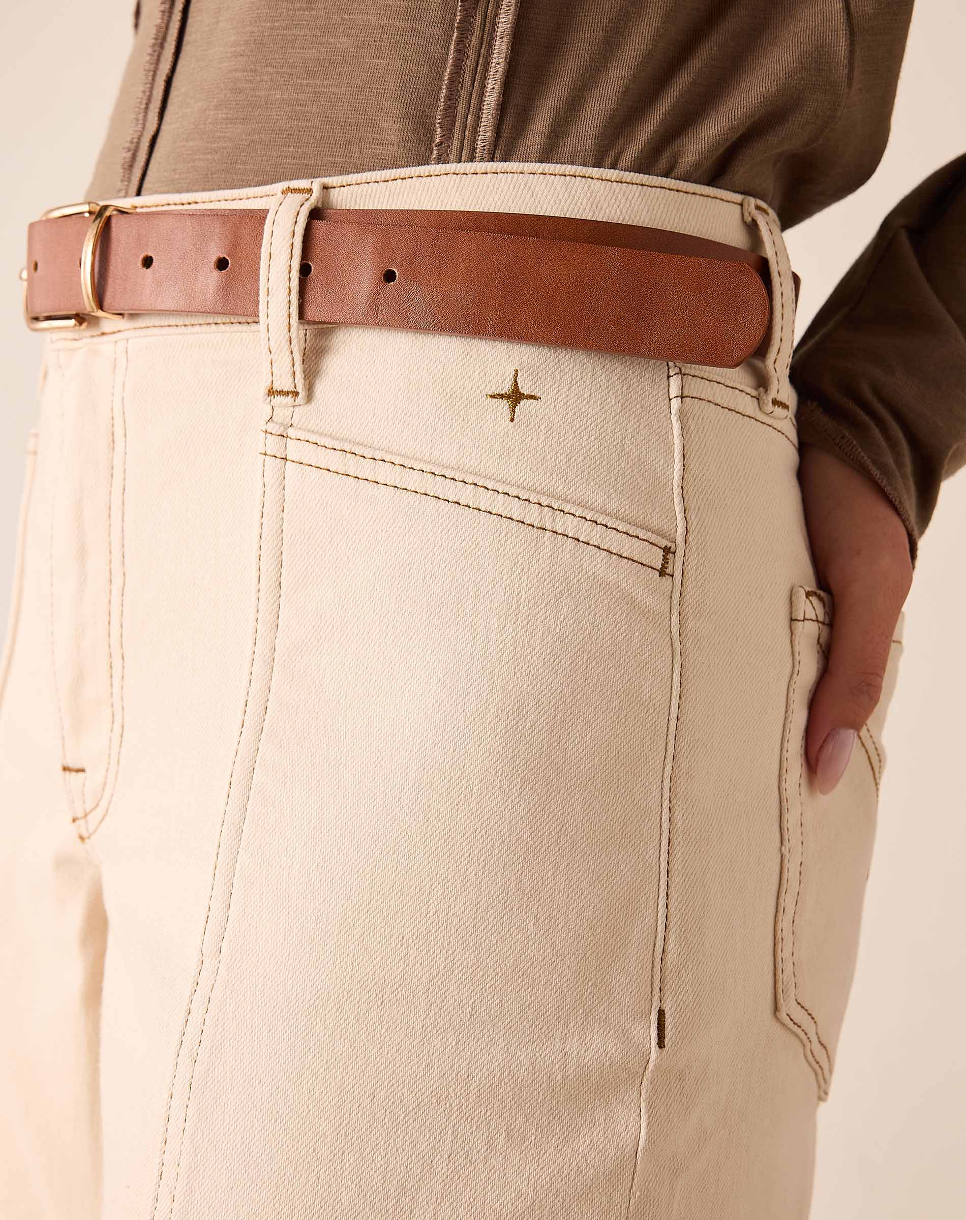 Oat-colored wide-leg trousers with a leather belt and unique stitching detail