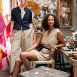 Two women in a room with vintage decor and furniture.