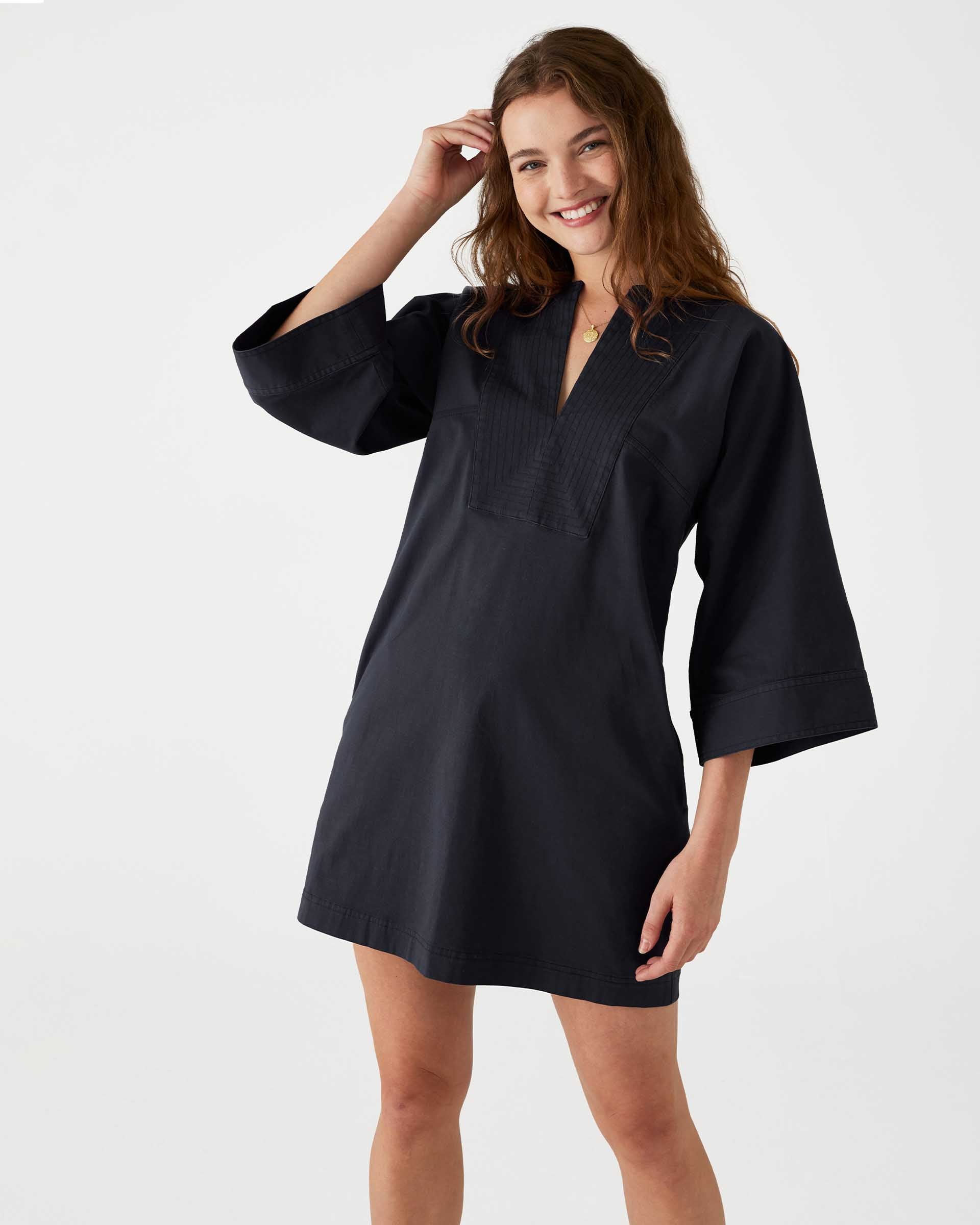 woman showcasing mersea navy tunic dress with v neck