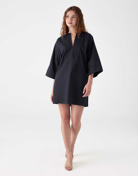 woman showcasing mersea navy tunic dress with v neck