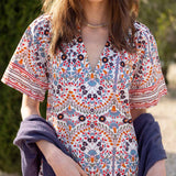 MERSEA ladies' travel-ready women's travel-friendly multi-colored arched floral print tunic dress with a V-neckline and short sleeves.