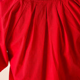 Close-up of a red garment with a plain background