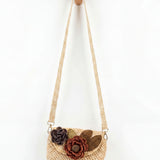 Woven handbag with floral decorations on a white background
