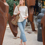 Woman walking outdoors near artistic metal sculptures