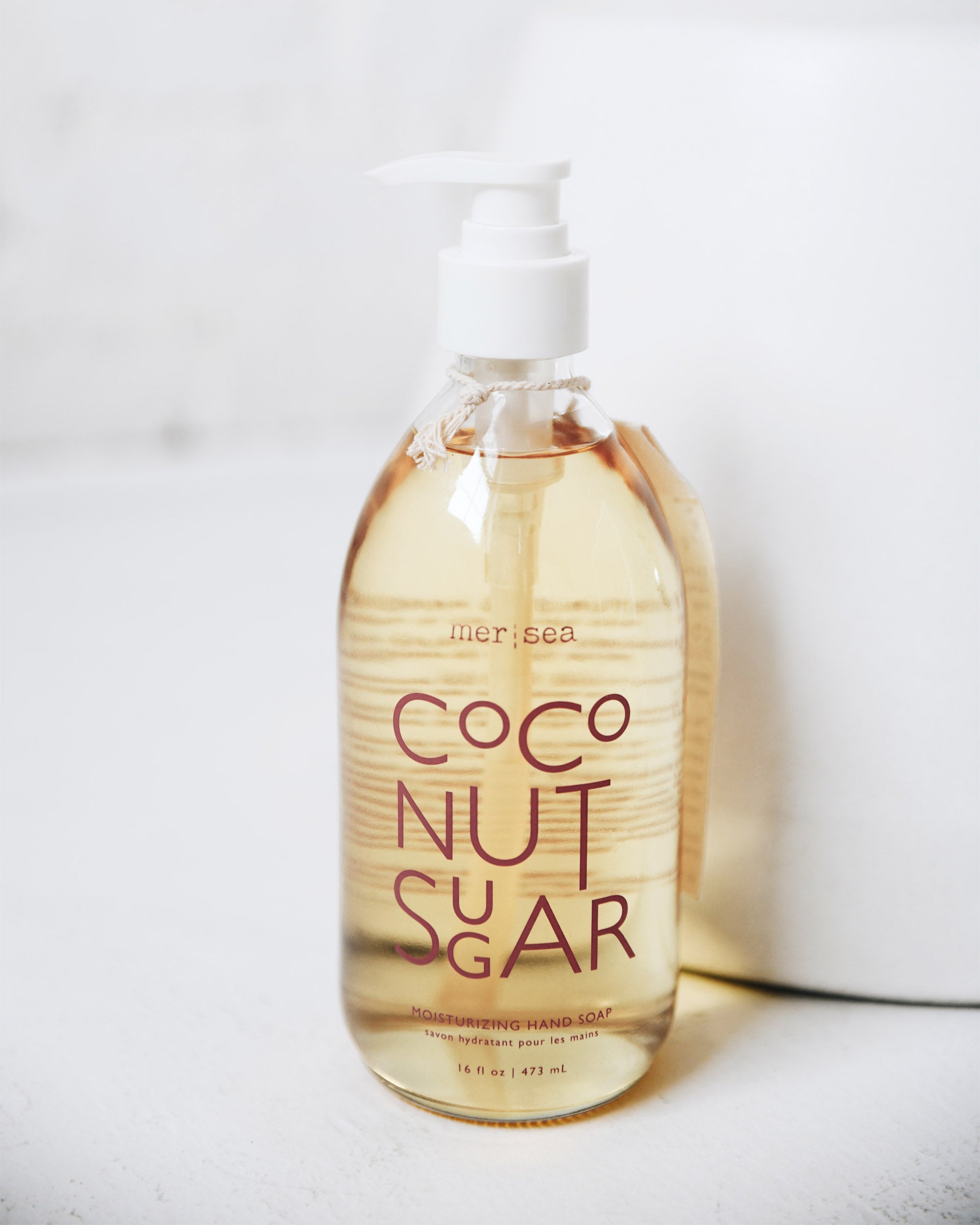 large coconut sugar liquid hand soap sitting on white counter