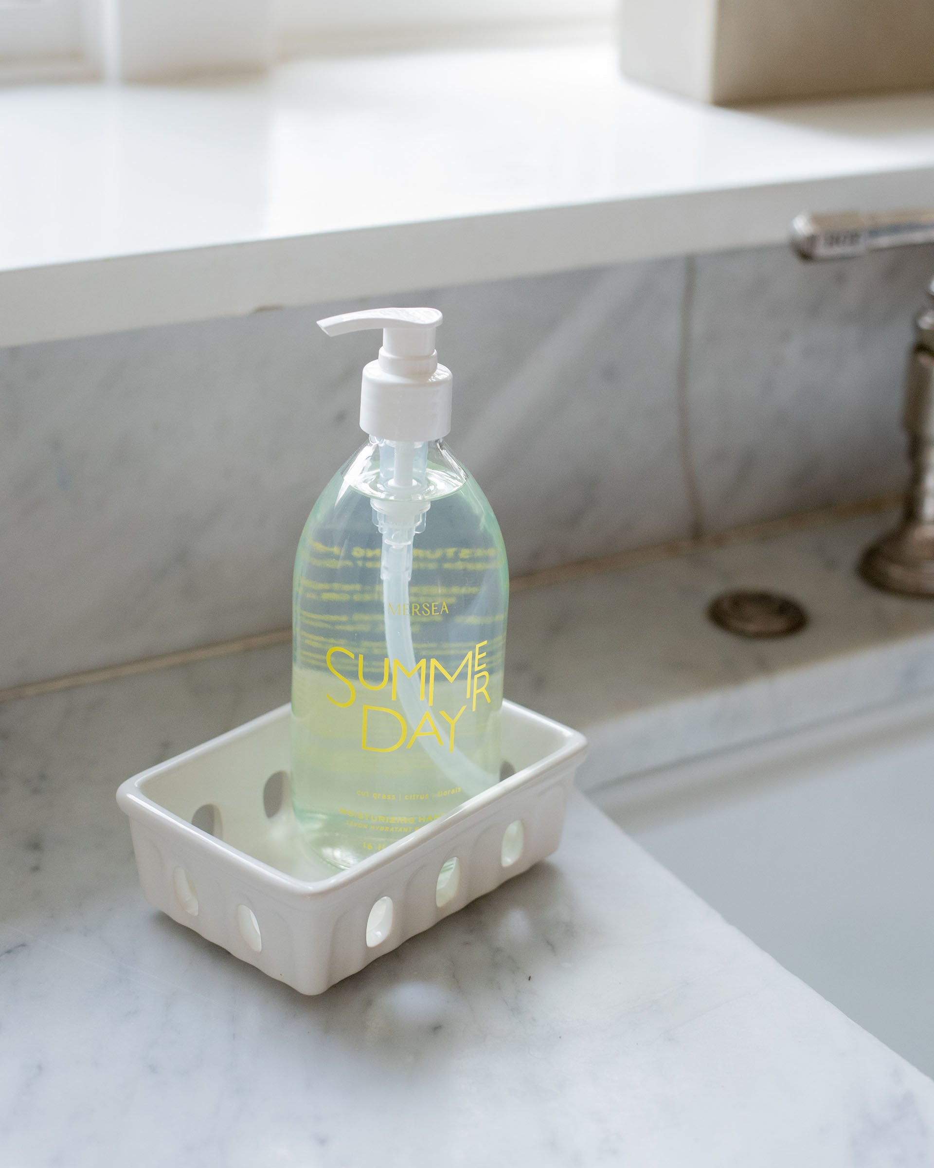 summer day hand soap sitting by sink