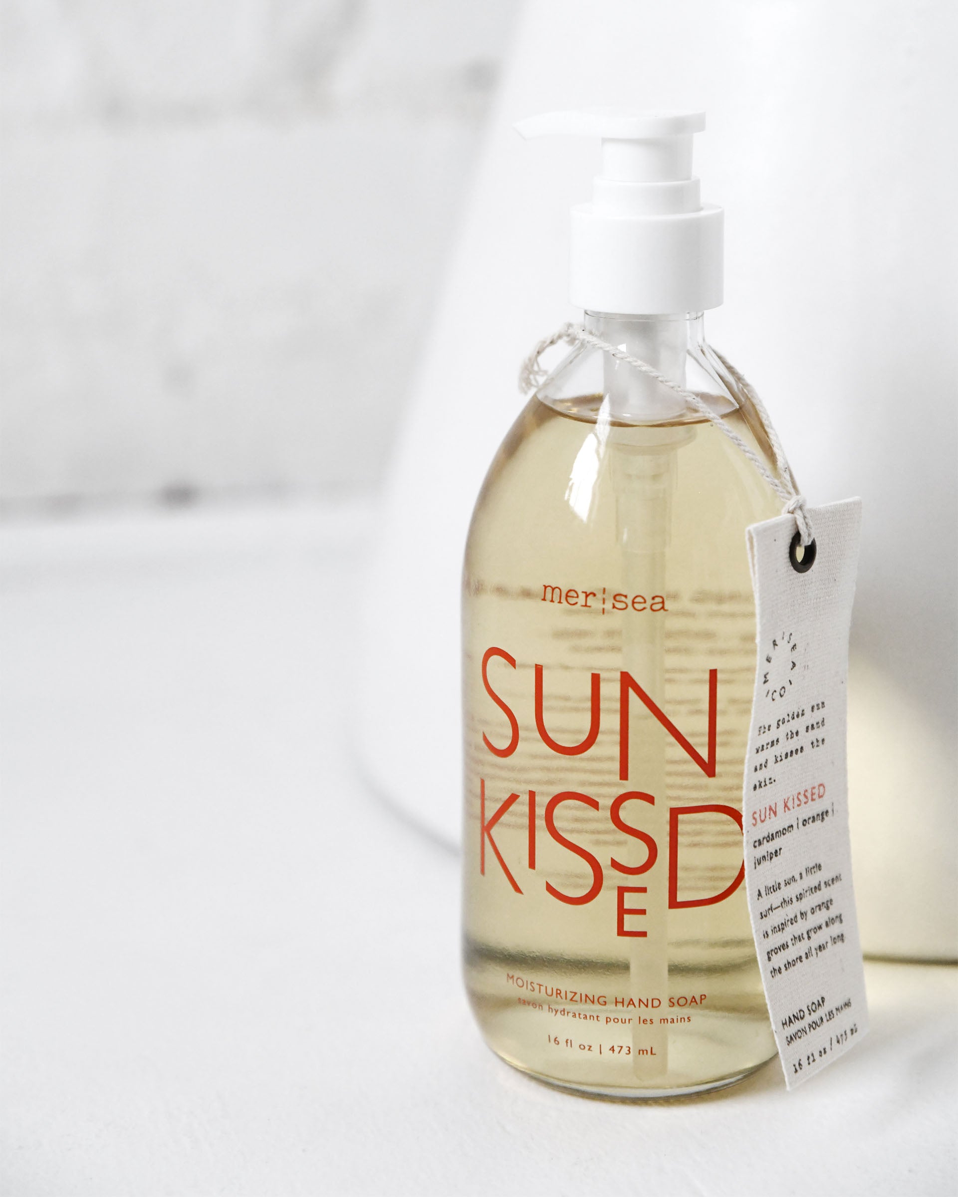 large sun kissed liquid hand soap sitting on white counter