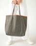 woman holding le canvas tote in gray