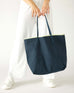 woman holding le canvas tote in navy