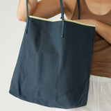 woman holding le canvas tote in navy