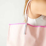 le canvas tote on woman's shoulder