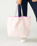 woman holding le canvas tote in pink