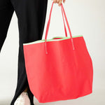 woman holding le canvas tote in watermelon