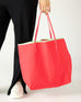 woman holding le canvas tote in watermelon