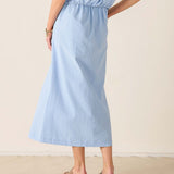 Light blue dress worn by a person on a beige background