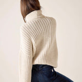 Cream ribbed turtleneck sweater.