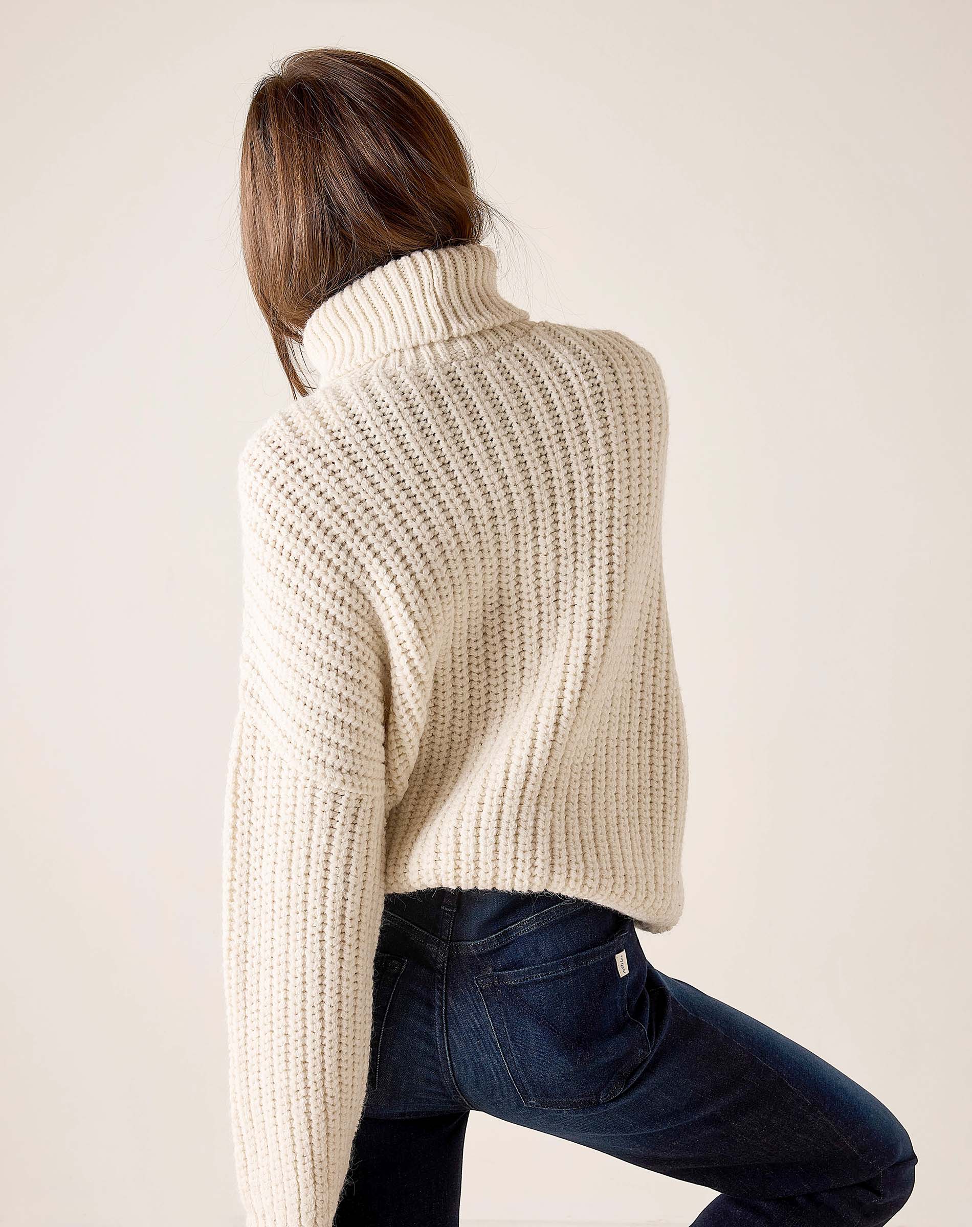Cream ribbed turtleneck sweater.