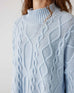 closeup of woman wearing Mersea lisbon sky blue sweater
