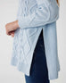 closeup of side of woman wearing Mersea lisbon sky blue sweater
