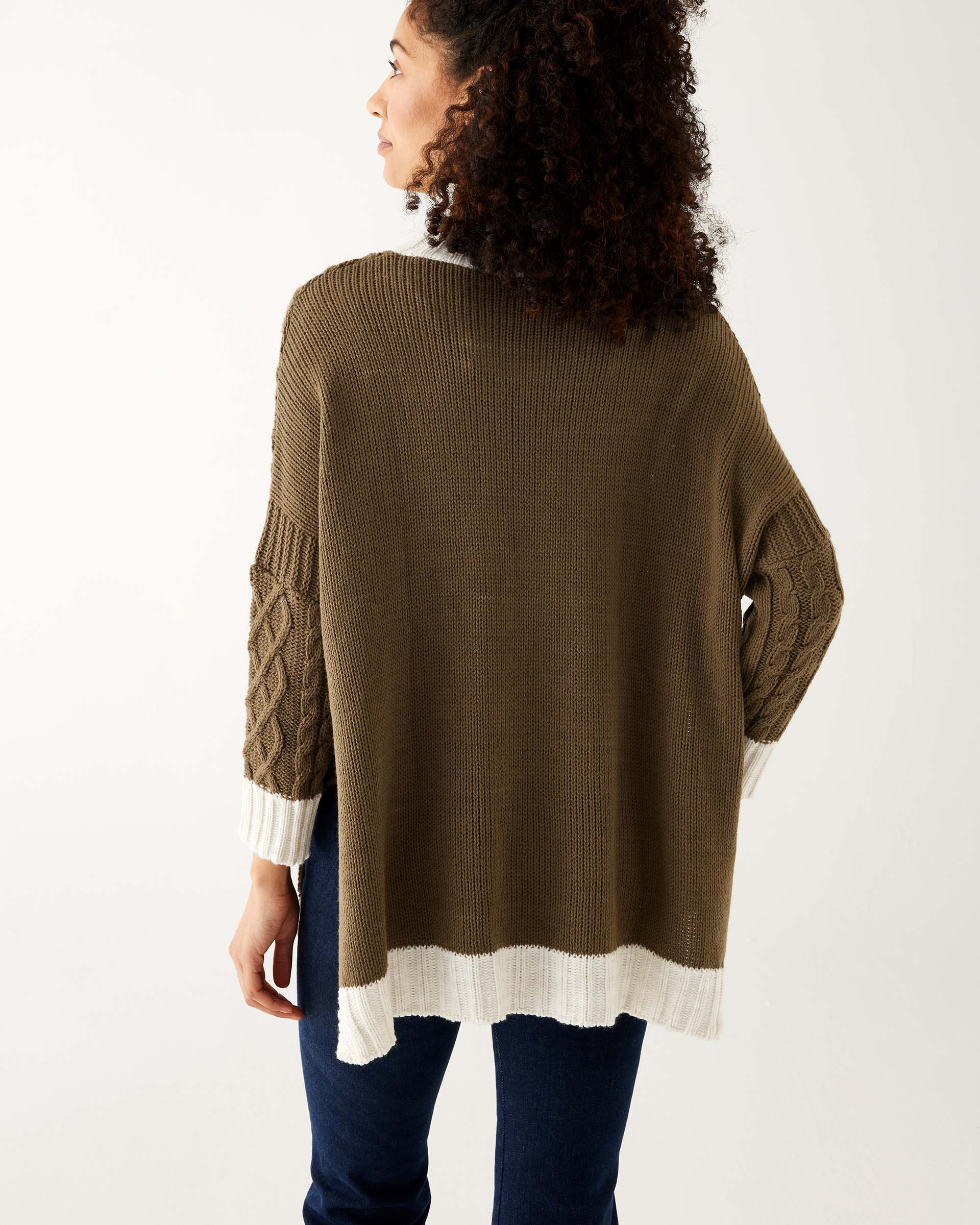 rear view of woman wearing mersea lisbon traveler sweater in olive and seasalt