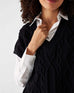 closeup of vneck on woman wearing Mersea lisbon black sweater vest