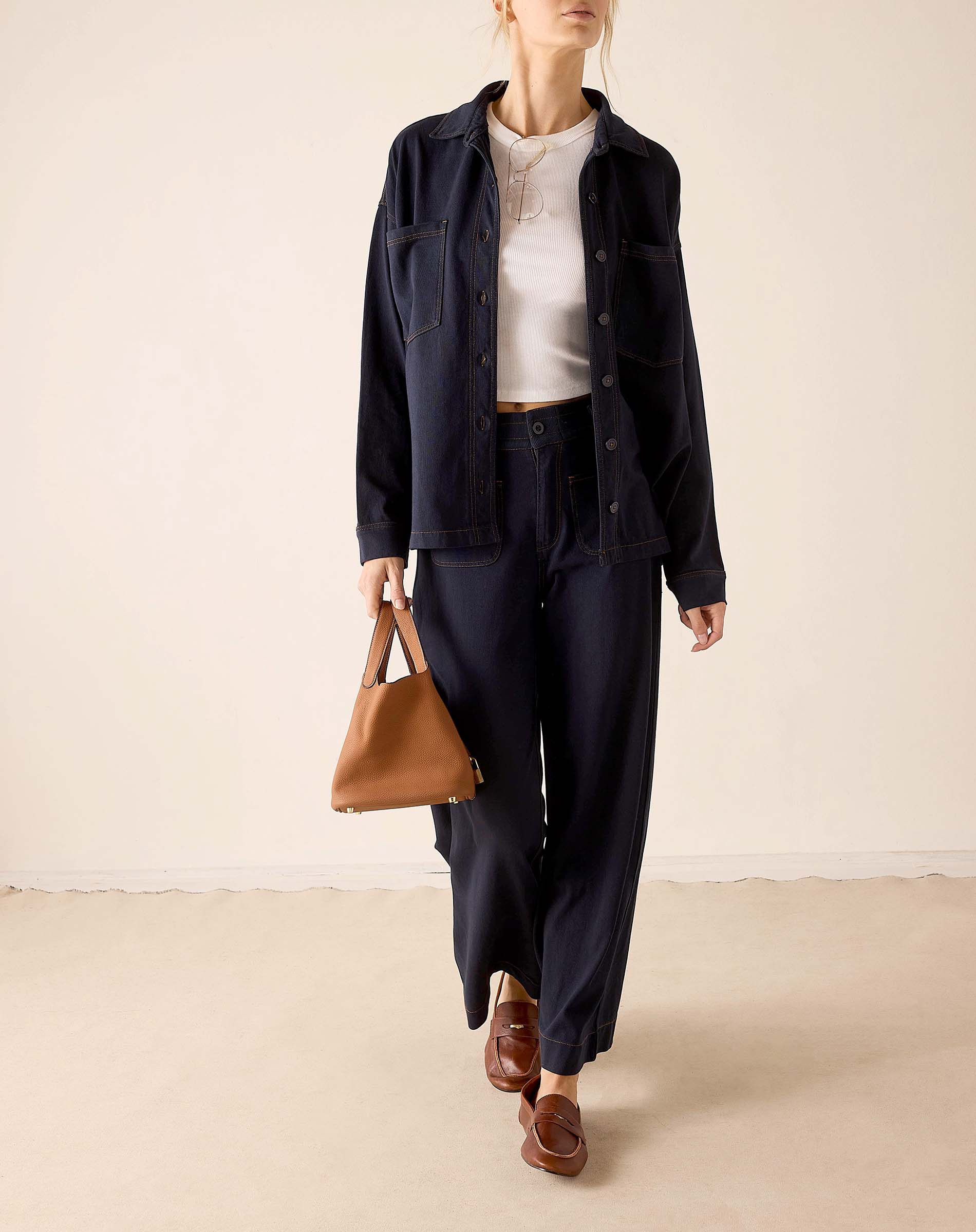 Navy blue heavy jersey knit pants with a wide leg silhouette.