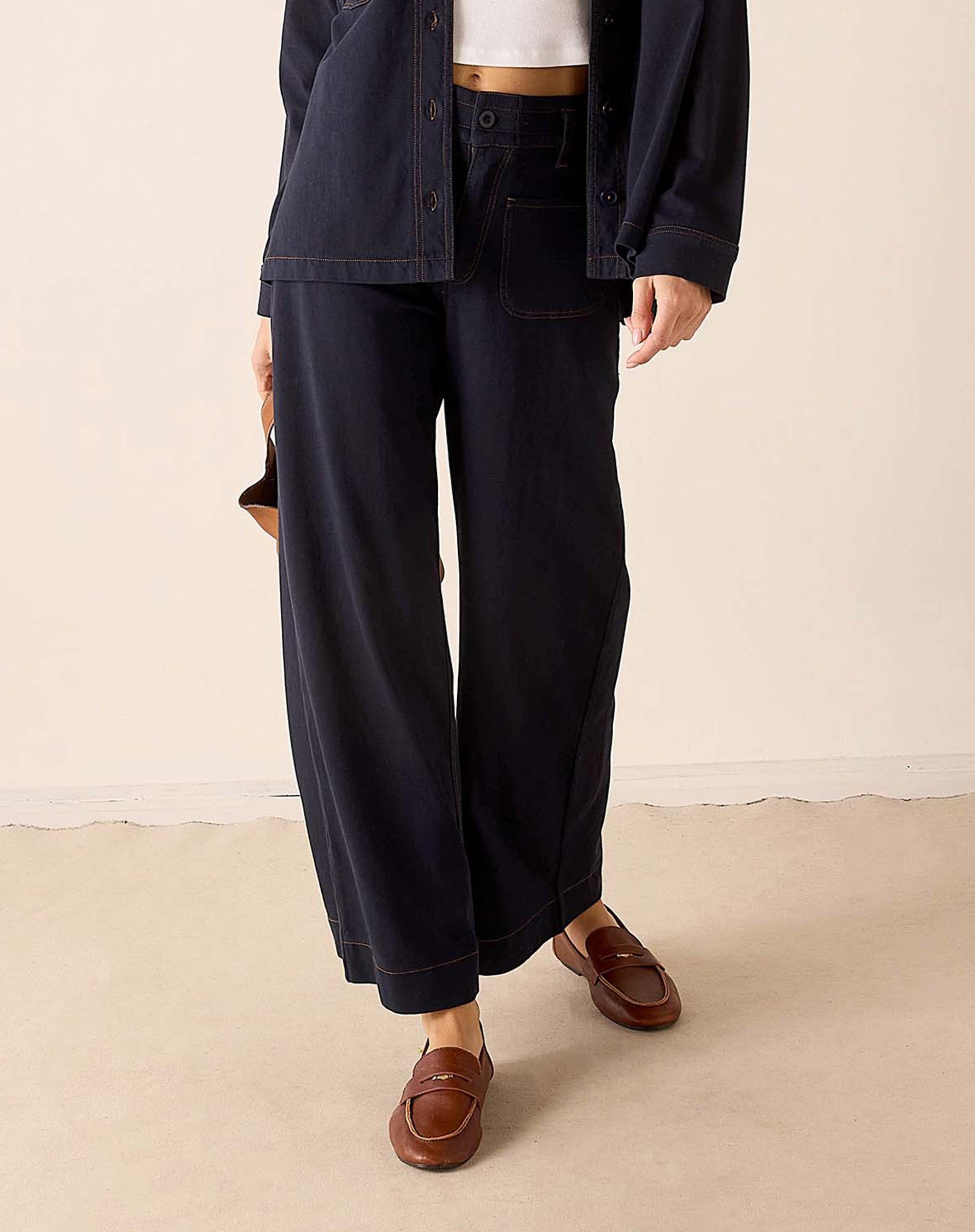 Navy blue heavy jersey knit wide-leg pants with a relaxed fit and straight hem.