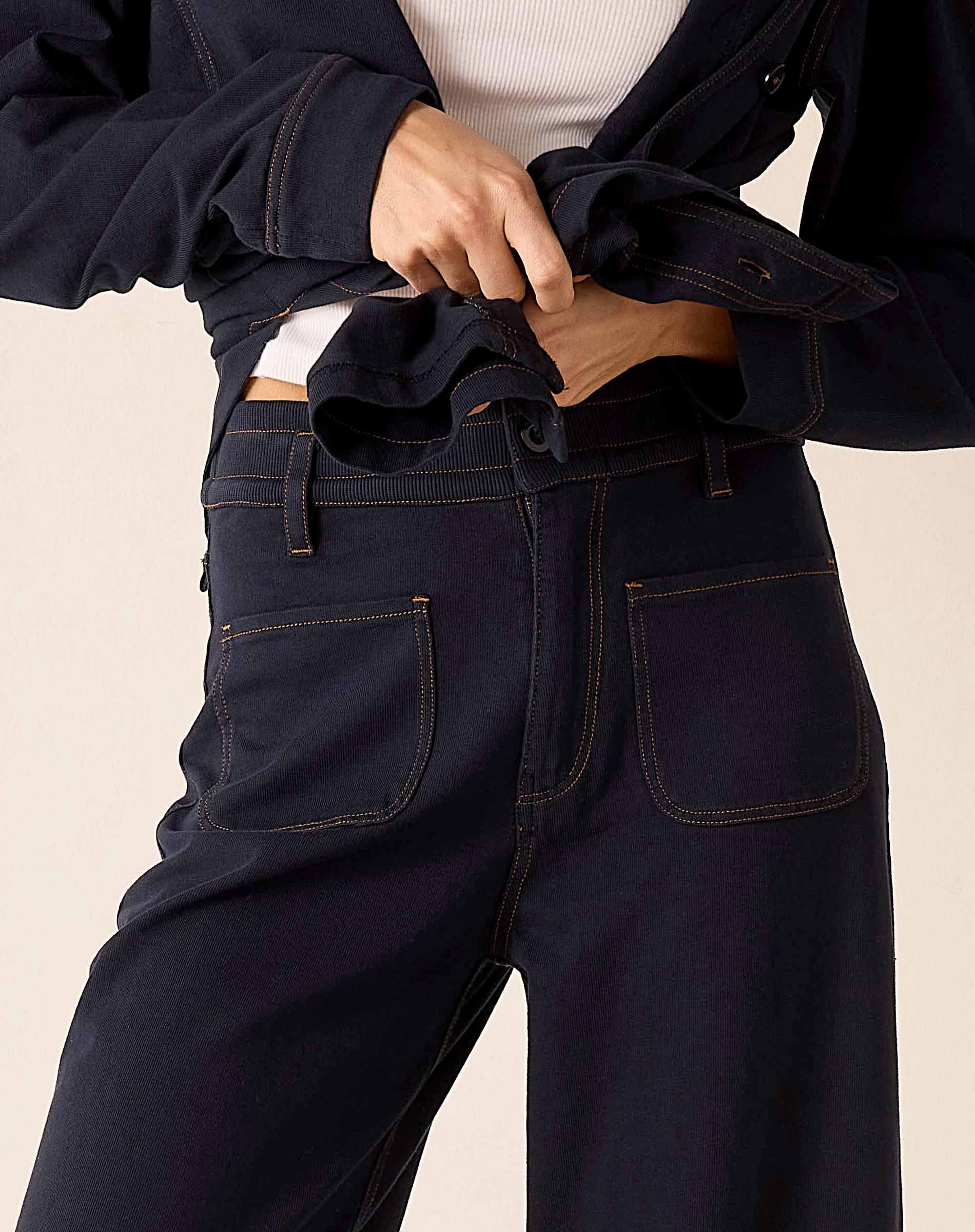 Navy blue heavy jersey pants featuring a high-waisted fit and functional front pockets.