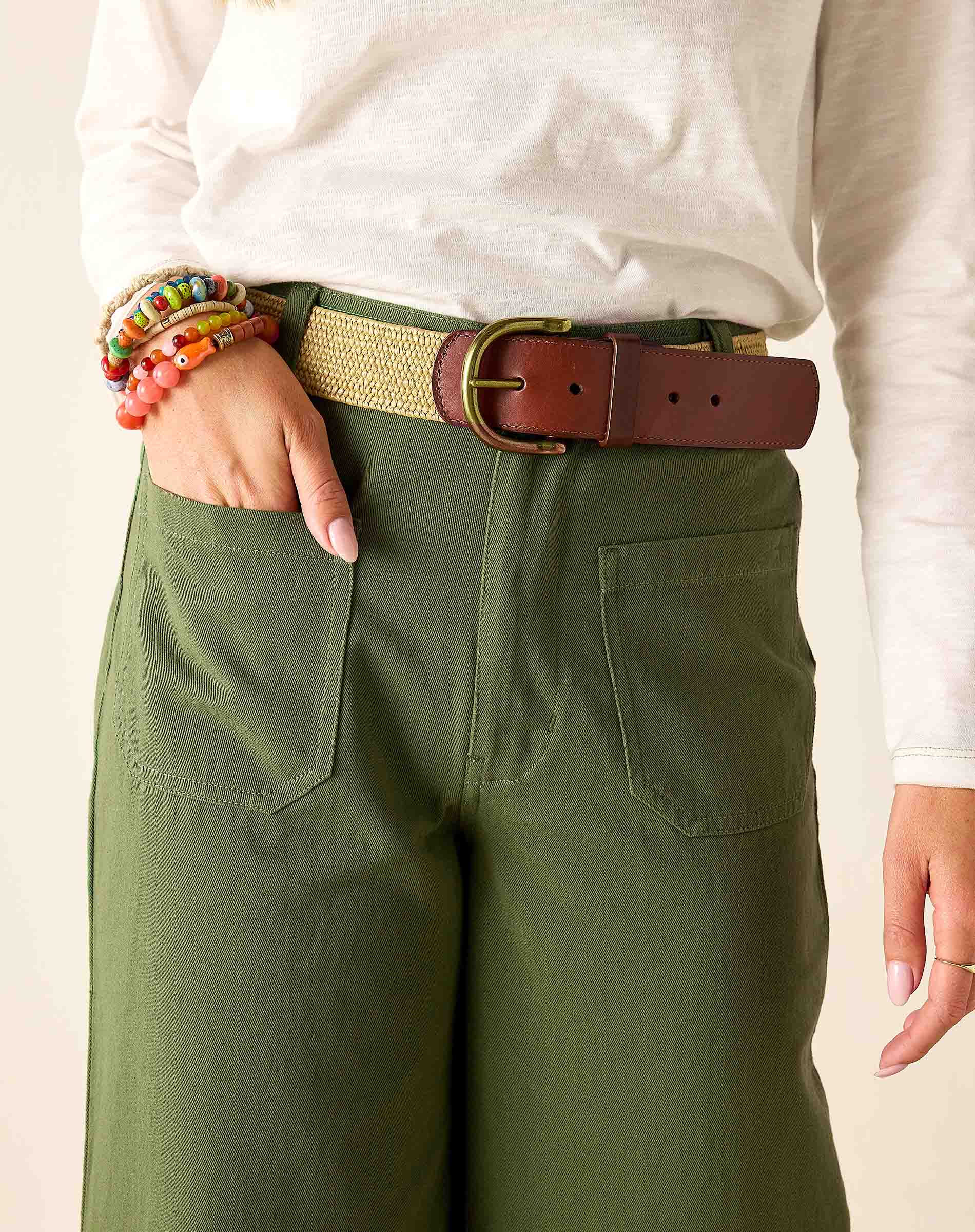 Olivine green twill trousers featuring a high-waisted fit and front pockets.