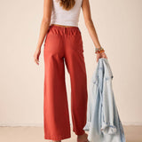 Persimmon twill wide-leg pants with an elastic waistband and front pockets.