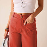 Persimmon twill high-waisted wide-leg pants with front pockets.