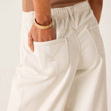 Person wearing beige pants with a neutral background