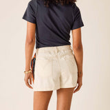 Person wearing a navy t-shirt and beige shorts on a plain background