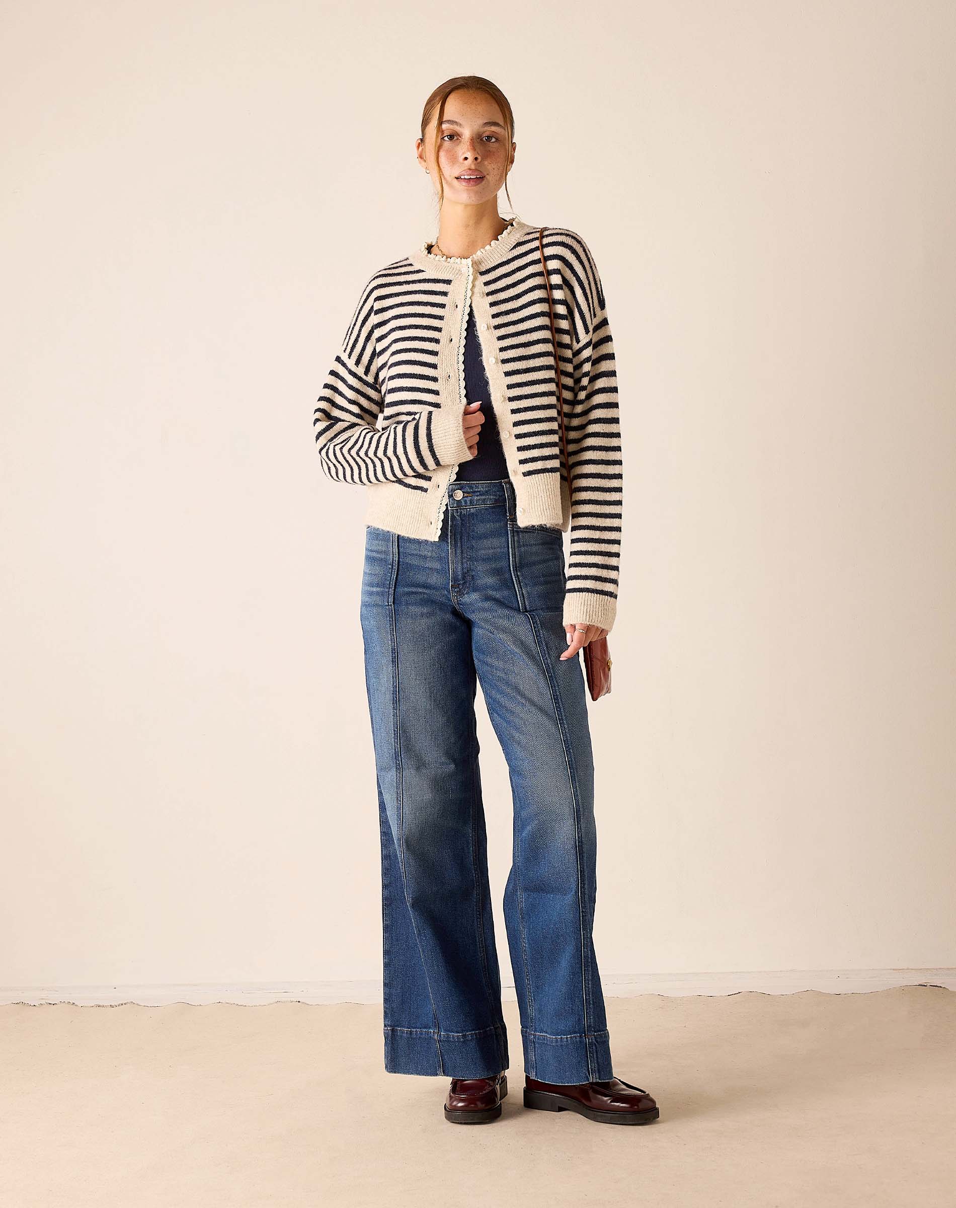Ladies' travel-ready navy and cream sailor stripe knit cardigan with a buttoned front.