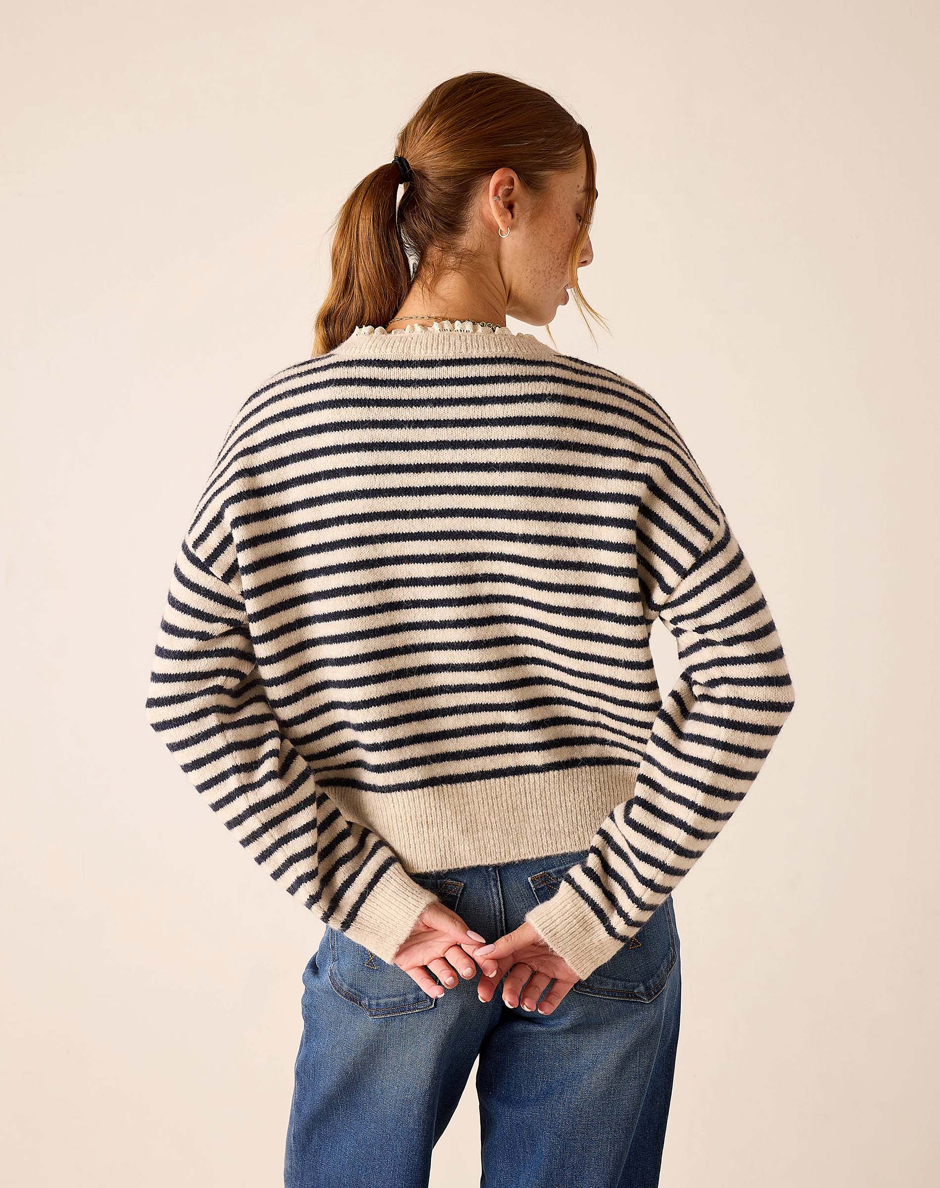 Navy and cream horizontal striped knit sweater with a relaxed fit and ribbed cuffs.