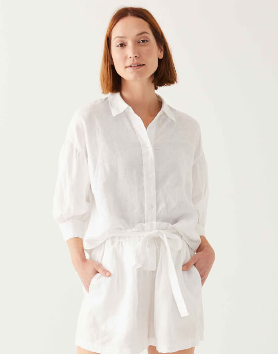 female wearing white linen button-down shirt with collar and matching shorts on white background