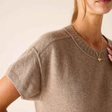 Model wearing a beige short-sleeved cashmere crewneck knit top.